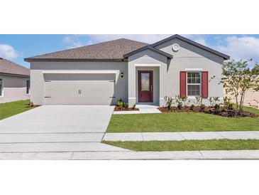 Beautiful single-story home with a two-car garage, manicured lawn, and inviting front entrance at 1633 Nantucket Way, Winter Haven, FL 33884