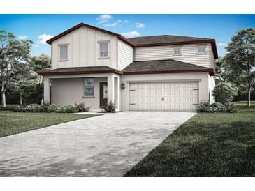 Charming two-story home featuring a two-car garage, inviting front porch, and beautifully landscaped surroundings at 1790 White Elephant Loop, Winter Haven, FL 33884