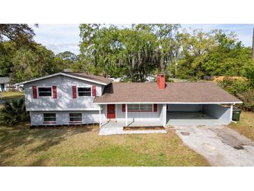 Charming two-story home featuring red shutters, gray siding, and a covered carport at 1326 Se 34Th Ter, Ocala, FL 34471