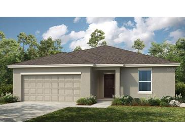 Charming one-story home with a two-car garage and well-maintained landscaping at 2411 Slippery Rock St, Auburndale, FL 33823
