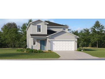 Charming two-story home with a well-manicured lawn, attached two-car garage, and stylish blue front door at 951 Hour Glass Rd, Lakeland, FL 33801