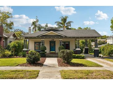 Charming home with a welcoming front porch, beautiful landscaping, and a well-maintained lawn at 515 Frank Lloyd Wright Way, Lakeland, FL 33803