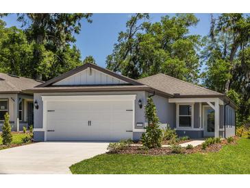 Charming single-story home featuring a two-car garage, well-manicured lawn, and attractive landscaping at 5433 Sw 82Nd Ter, Ocala, FL 34481