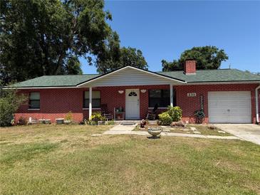 Charming single-story brick home with a well-maintained lawn and welcoming front porch at 231 Connie Lee Ct, Lakeland, FL 33809