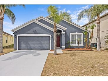 Charming single-Gathering home with a well-maintained lawn and an attached two-car garage at 438 Cotswold Cir, Davenport, FL 33837
