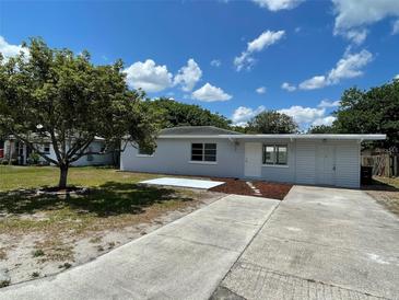 Charming single-story home with a well-maintained lawn, mature tree, and a long driveway at 213 5Th Jpv St, Winter Haven, FL 33880