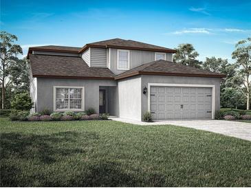 Charming two-story home with a two-car garage and well-manicured lawn at 13272 Tula Loop, Astatula, FL 34705