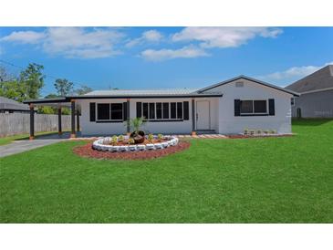Charming single-story home featuring a well-manicured lawn and decorative front garden at 1475 3Rd Ave, Deland, FL 32724