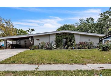 Charming single-story home with a covered carport and xeriscaped front yard with cacti and succulents at 2908 Maplewood Ave, Lakeland, FL 33803