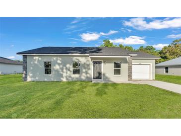 Charming single-story home with a well-maintained lawn and stone accents at 534 S Perry Ave, Fort Meade, FL 33841