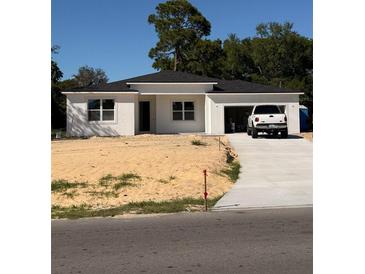 Charming single-story home with a welcoming entrance, attached garage, and well-manicured yard at 149 Grady Polk Rd, Winter Haven, FL 33880