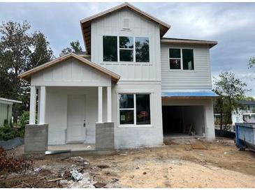 New construction two-story home featuring a two-car garage and bright white siding at 1205 Eastin Ave, Orlando, FL 32804