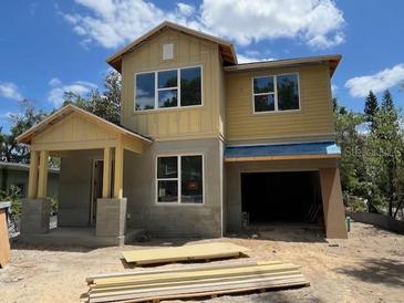 New home exterior with large windows and an attached garage is under construction on a sunny day at 1205 Eastin Ave, Orlando, FL 32804