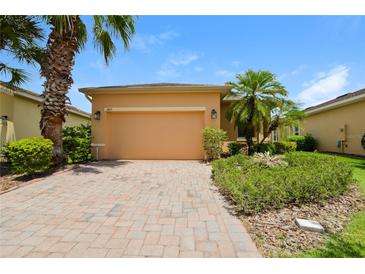 Charming single Gathering home featuring desert landscaping and a brick paver driveway at 1405 Harbor Ridge Dr, Kissimmee, FL 34759