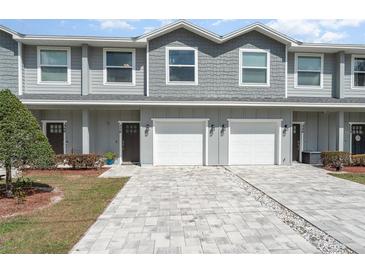 Charming townhome featuring a gray exterior, attached garage, and well-maintained landscaping at 350 N 1St Ave, Bartow, FL 33830