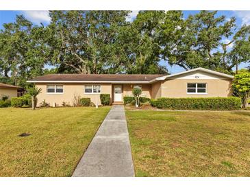 Lovely single-story house with a long walkway leading to the front door at 4915 Whiteoak E Dr, Lakeland, FL 33813