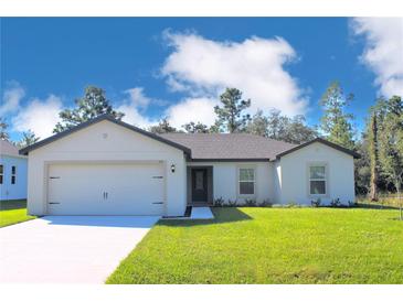 Charming single-story home with a two-car garage and well-manicured lawn on a sunny day at 318 Bowfin Ct, Poinciana, FL 34759