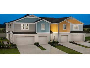 Charming townhomes feature colorful exteriors, private garages, and manicured landscaping, perfect for modern living at 3766 King Hill Dr, Haines City, FL 33844