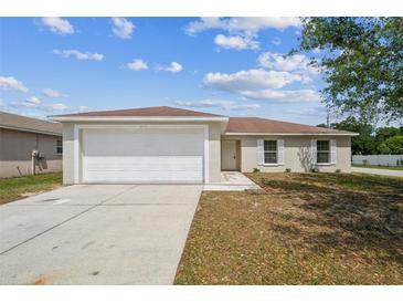 Charming single-story home featuring a two-car garage and well-maintained lawn at 1628 Saddlehorn Dr, Lakeland, FL 33810