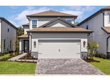 Charming two-story home with neutral exterior and a spacious two-car garage at 7705 Somersworth Dr, Kissimmee, FL 34747