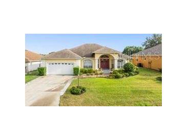 Inviting one-story home with a well-manicured lawn and attached two-car garage at 2522 Pine Valley Dr, Lakeland, FL 33810
