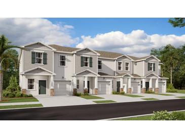 Charming townhomes featuring a modern design, private garages, and manicured landscaping at 3098 Chantilly Dr, Davenport, FL 33837