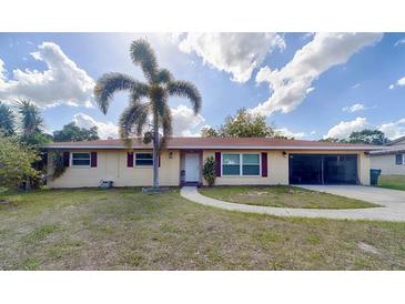 Charming single-story home with a well-maintained lawn and a mature palm tree in the front yard at 4621 Queens Point Drive, Lakeland, FL 33813