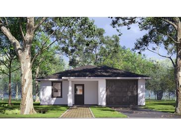 Charming single-story home featuring a brick walkway, attached garage, and inviting front door at 332 W 8Th St, Lakeland, FL 33805