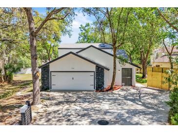Charming home featuring an attached two car garage, mature trees and easy to maintain landscaping at 130 Stag Ridge Ct, Longwood, FL 32779