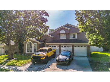 Beautiful two story home with manicured lawn and three-car garage at 1315 Olympia Park Cir, Ocoee, FL 34761