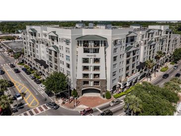 Modern apartment building featuring a brick entrance, balconies, and stylish architectural details at 2305 Edgewater Dr # 1606, Orlando, FL 32804