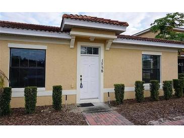 Charming single-story home featuring a red tile roof and tidy landscaping at 1758 Coriander Dr # 1758, Poinciana, FL 34759