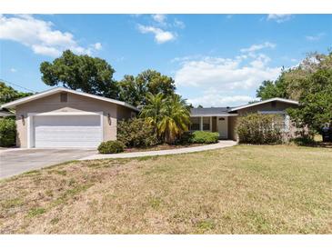 Charming single-story home with a well-maintained front yard and attached garage at 4012 Shorecrest Dr, Orlando, FL 32804