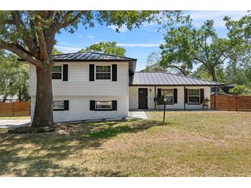 Charming two-story home with a well-manicured lawn and beautiful curb appeal under a sunny sky at 1352 Charlotte St, Altamonte Springs, FL 32701