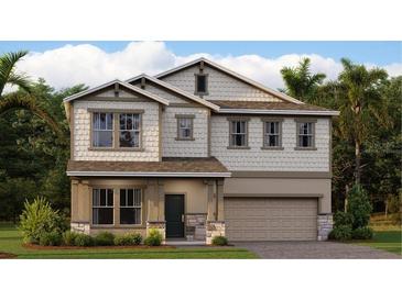 Charming two-story home featuring a covered porch and a two-car garage with manicured lawn at 3207 Armstrong Ave, Clermont, FL 34714