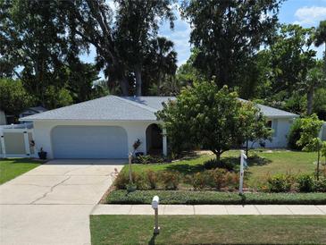 Well-maintained home featuring a charming front yard and a freshly painted white exterior with an attached garage at 3446 Country Manor Dr, Port Orange, FL 32129