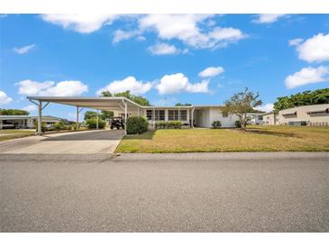Charming single-story home featuring a carport and a cozy front porch with manicured landscaping and bright white paint at 1610 Reynolds Rd # 353, Lakeland, FL 33801