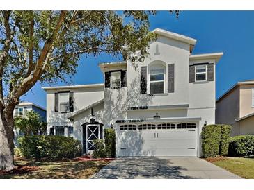 Charming two-story home boasts a well-manicured lawn and a welcoming two-car garage at 6918 Lake Eaglebrooke Dr, Lakeland, FL 33813