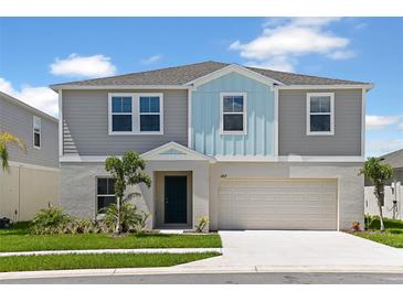 Charming two-story home featuring a two-car garage, landscaped yard and inviting curb appeal at 1620 Ellesmere Ave, Haines City, FL 33844