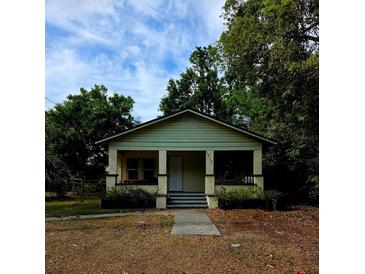 Charming bungalow with a covered front porch and classic architectural details in a treed yard at 1710 Hamilton St, Bartow, FL 33830