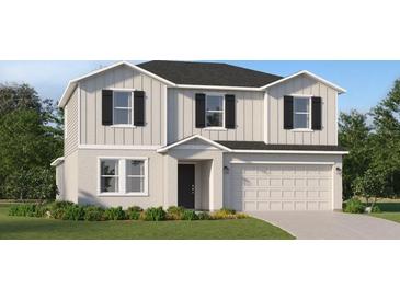Charming two-story home featuring a two-car garage, black shutters and inviting front yard at 1313 Hammock Reserve Dr, Deland, FL 32720
