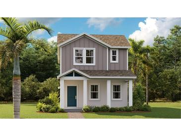 Charming two-story home with gray siding, white trim, a welcoming porch, and lush landscaping at 606 Terrapin Dr, Debary, FL 32713