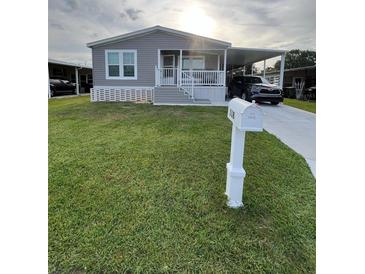 Charming single-story home featuring a carport and well-maintained lawn at 118 Jana Cir, Auburndale, FL 33823