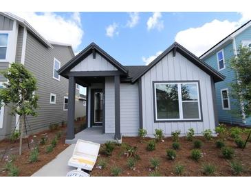 Charming single-Gathering home with inviting front porch and beautifully landscaped front yard at 3102 Voyager Ave, St Cloud, FL 34771
