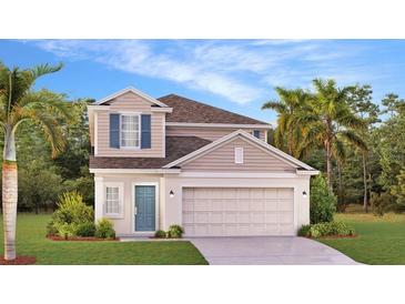 Charming two-story home featuring a two-car garage, inviting entryway, and landscaped front yard at 5657 Portico Pl, Kissimmee, FL 34758