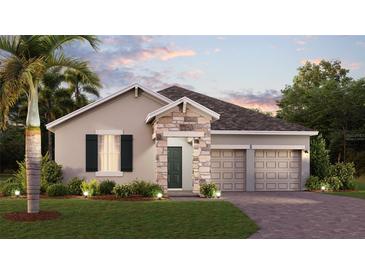 Charming single-Gathering home featuring stone accents, a two-car garage, and professionally landscaped front yard at 1899 Clear Sky Dr, Kissimmee, FL 34744