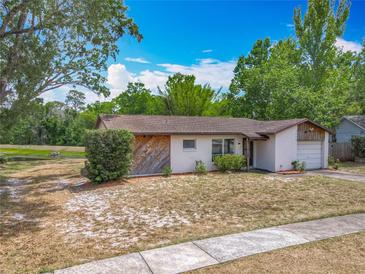 Charming single-story home featuring a well-maintained lawn and attached garage at 9526 Turkey Oak Bnd, Orlando, FL 32817