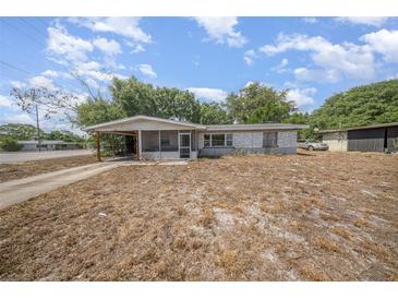 View of home, featuring covered carport and screen porch in need of renovation at 129 5Th Jpv St, Winter Haven, FL 33880