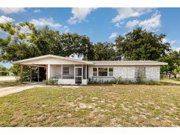 Charming single-story home featuring a screened-in porch and a carport at 129 5Th Jpv St, Winter Haven, FL 33880