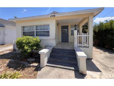 Charming home featuring a covered porch, and a quaint, landscaped front yard at 206 W 9Th St, Lakeland, FL 33805